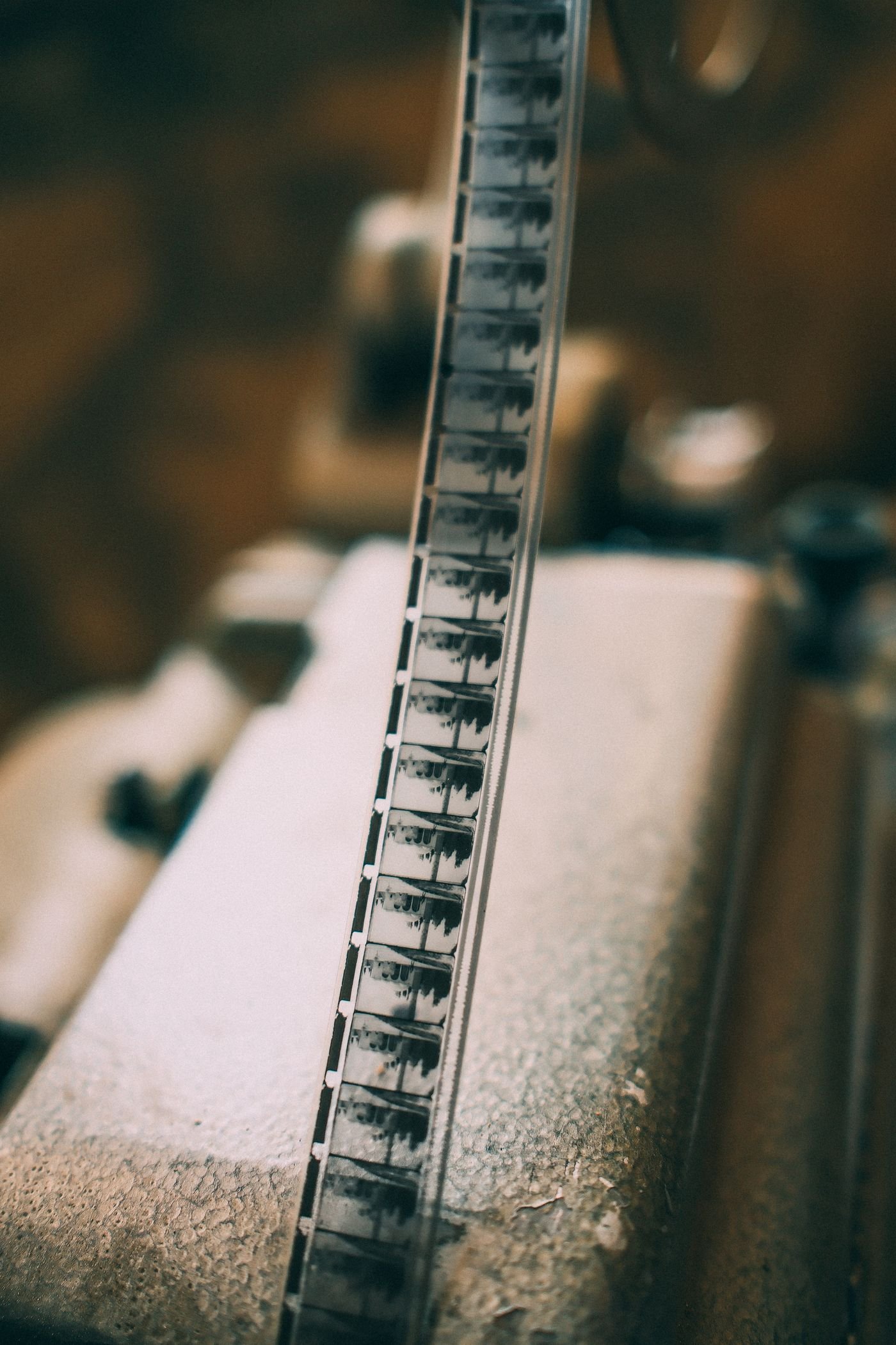 A strip of cine film running through the gate of a vintage projector